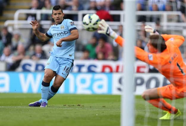 Manchester City substitute Sergio Aguero fires his shot past Newcastle United goalkeeper Tim Krul. Picture: AFP/Getty