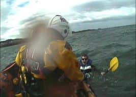 The dramatic moment the North Berwick lifeboat reaches the first kayaker. Picture: Contributed