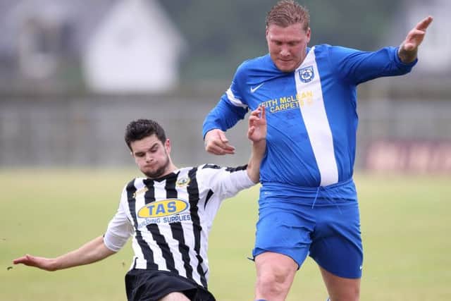 Selkirk striker Garry O'Connor fights for the ball with a Threave Rovers defender at Yarrow Park. Picture: Brian Sutherland