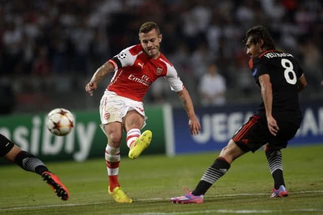 Arsenal midfielder Jack Wilshere kicks the ball as Besiktass Veli Kavlak, right, looks on in last nights match in Istanbul. Picture: Getty