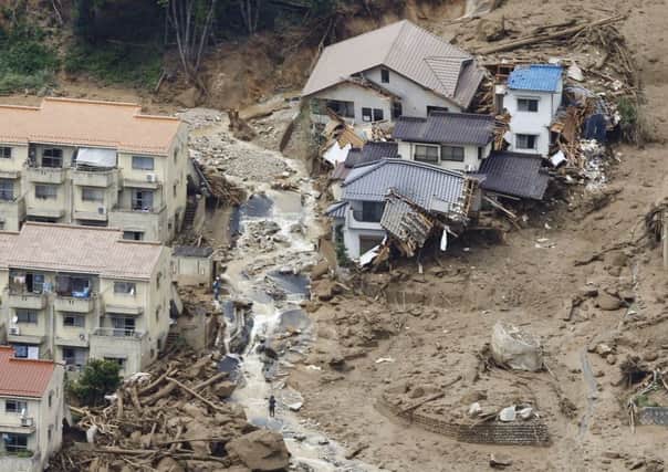 Rescue workers search for survivors after a massive landslide swept through Hiroshima. Picture: AP