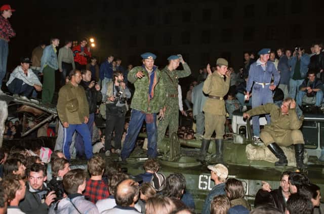 On this day in 1991, Soviet soldiers defending Russian president Boris Yeltsin try to calm a crowd of demonstrators. Picture: Getty
