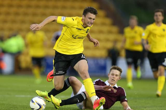 Michael McKenna of Livingston is tackled by Hearts' Angus Beith. Picture: Getty Images