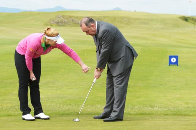 Kylie Walker gives the First Minister some tips on putting at North Berwick Golf Club yesterday. Picture: Phil Wilkinson
