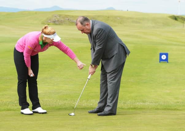 Kylie Walker gives the First Minister some tips on putting at North Berwick Golf Club yesterday. Picture: Phil Wilkinson