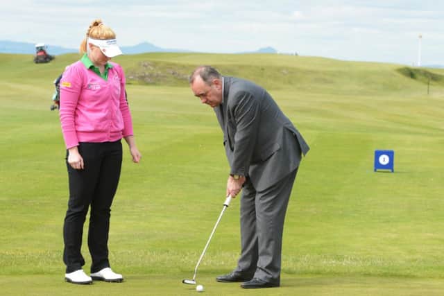 Kylie Walker gives the First Minister some tips on putting at North Berwick golf course. Picture: Phil Wilkinson