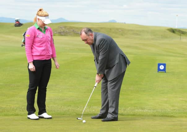 Kylie Walker gives the First Minister some tips on putting at North Berwick golf course. Picture: Phil Wilkinson
