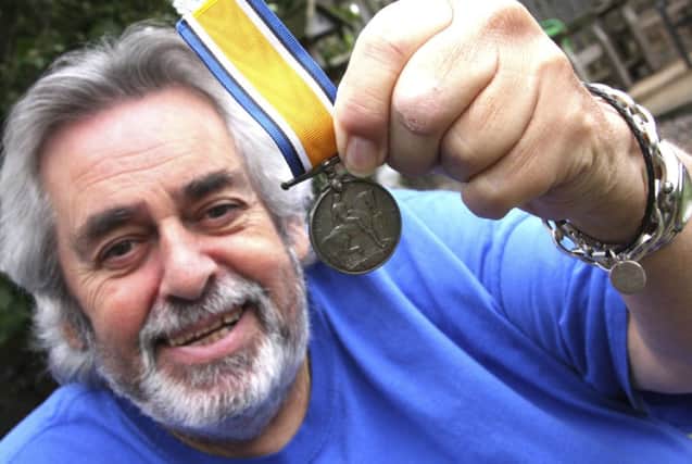 Pete Carson with the medal



 he found at the bottom of a castle well. Picture: Cascade
