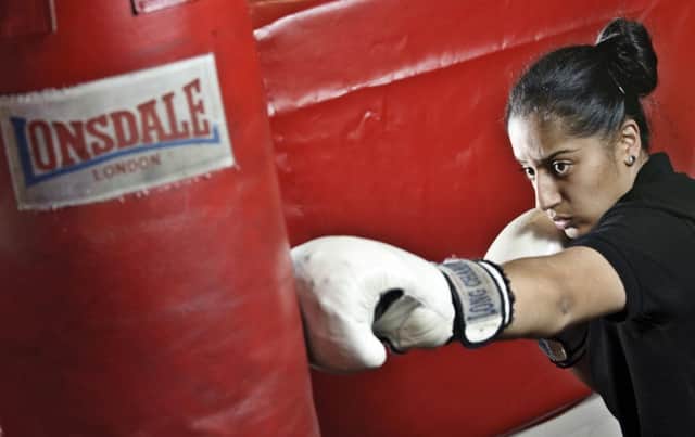 A women hits a punchbag in No Guts, No Heart, No Glory. Picture: Contributed