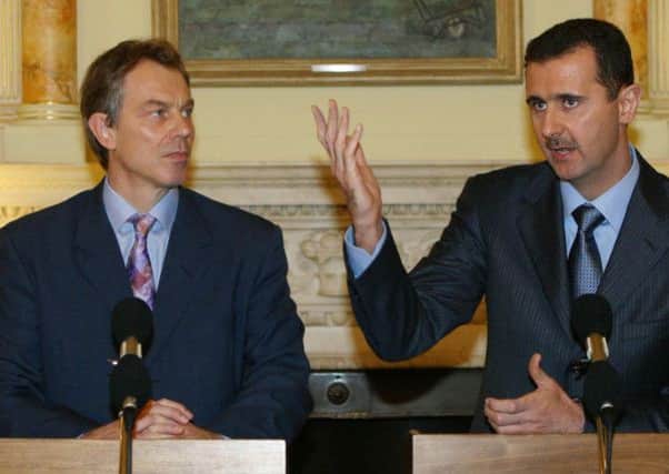 Former prime minister Tony Blair with Bashar Assad in 2002. Picture: PA