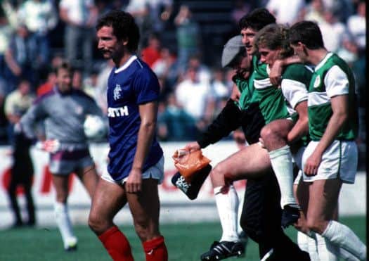 Graeme Souness leaves the field on his Rangers debut after receiving a red card for a challenge on Hibs' George McCluskey, who is helped off the pitch. Picture: SNS