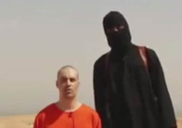 Brutal killer: the jihadist called John posing before the  brutal execution of American journalist James Foley. Picture: AP