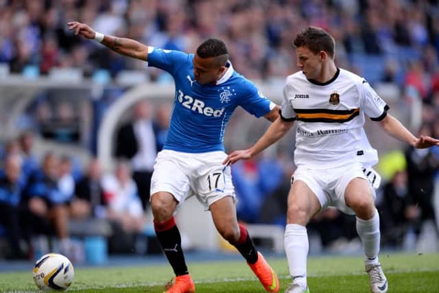 Rangers'
Arnold Peralta (left) holds off Dumbarton's Mitchel Migginson. Picture: SNS
