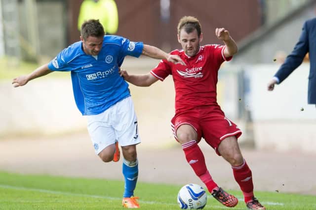 St Johnstone's Chris Millar challenges Niall McGinn (right). Picture: SNS