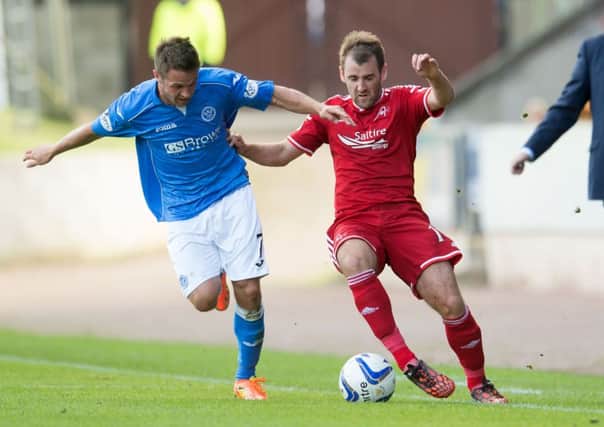 St Johnstone's Chris Millar challenges Niall McGinn (right). Picture: SNS