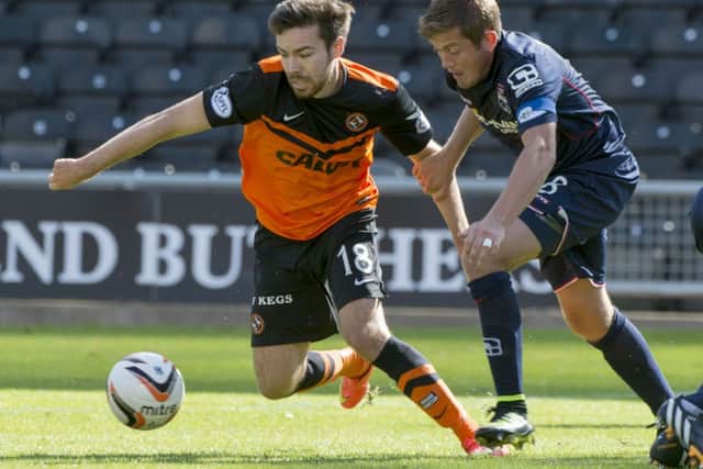 Dundee Utd star Ryan Dow gets away from Richard Brittain (right). Picture: SNS