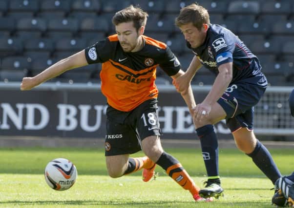 Dundee Utd star Ryan Dow gets away from Richard Brittain (right). Picture: SNS