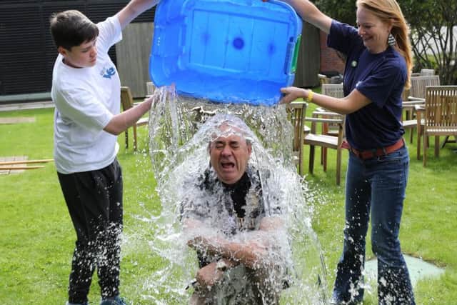 Alex Salmond gets a soaking as he completes the ice bucket challenge. Picture: Alan Milligan