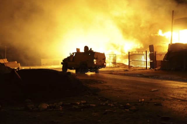 A building burns following clashes between rival militias in the Sarraj district of Tripoli at the weekend. Picture: Reuters