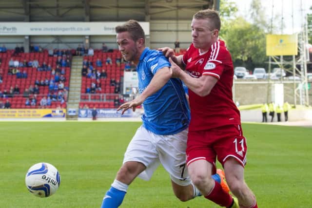 Chris Millar, left, holds off Aberdeens Jonny Hayes as the Perth side claimed all three points. Picture: SNS