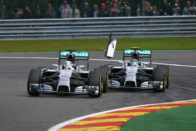 Nico Rosberg of Germany, right, makes contact with his Mercedes teammate Lewis Hamilton. Picture: Getty