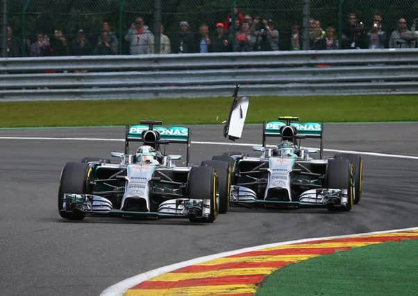 Nico Rosberg of Germany, right, makes contact with his Mercedes teammate Lewis Hamilton. Picture: Getty