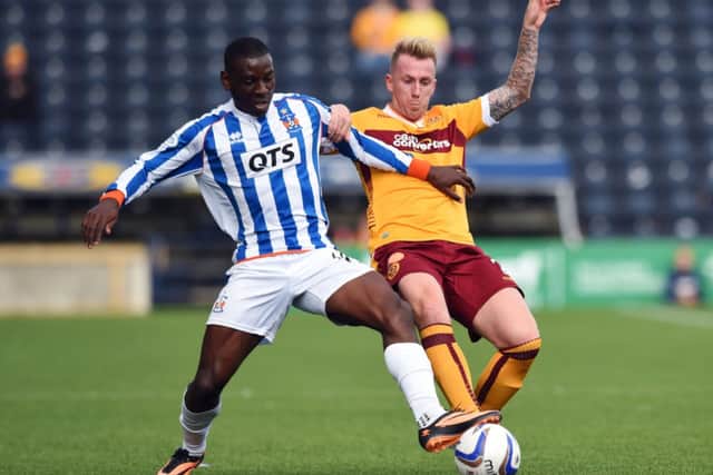 Kilmarnock forward Tope Obadeyi jousts with Motherwells Craig Reid. Picture: SNS