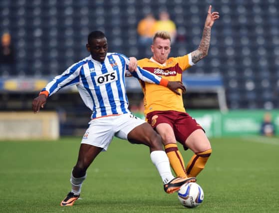 Kilmarnock forward Tope Obadeyi jousts with Motherwells Craig Reid. Picture: SNS