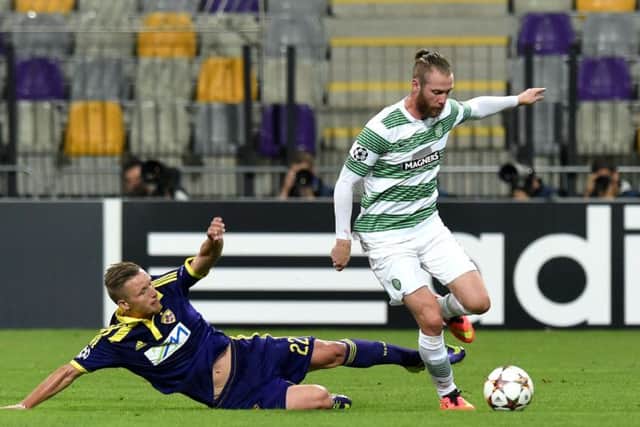 Dare Vrsic (left) slides in on Jo Inge Berget of Celtic. Picture: SNS