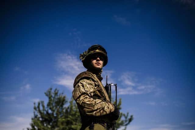 A Ukrainian soldier stands guard at a checkpoint on a road near Dnepropetrovsk. Picture: Getty Images