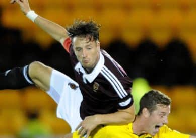 Hearts Brad McKay and Livingstons Jordan White clash in last weeks cup tie. Picture: Jane Barlow