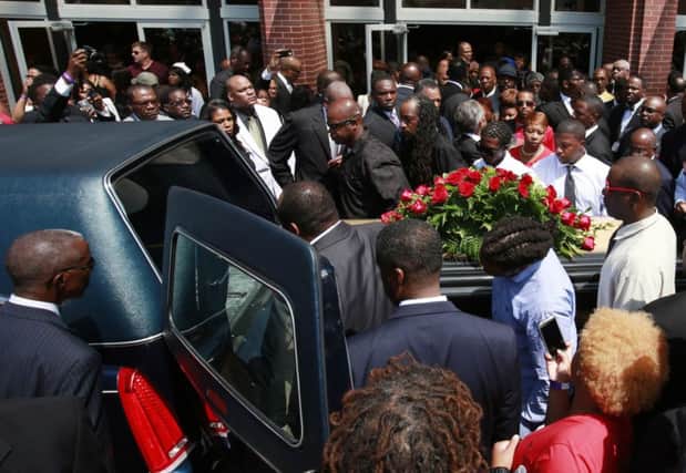 Michael Browns coffin is lifted into the hearse. Picture: Reuters