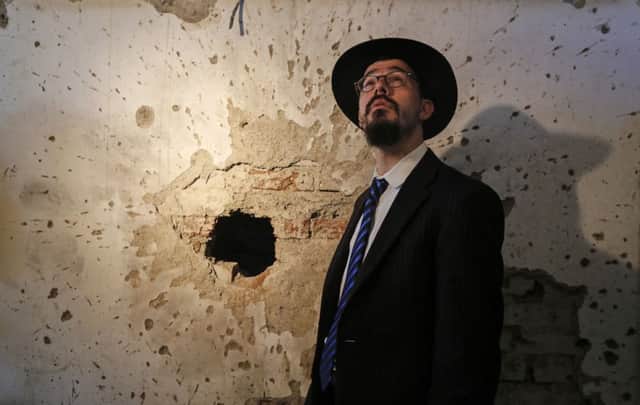 A rabbi at the opening of rebuilt Nariman House, which retains the scars of attack. Picture: Reuters