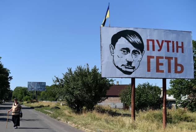 A billboard depicting Russian president Vladimir Putin as Adolf Hitler near Donetsk in eastern Ukraine. Picture: Getty