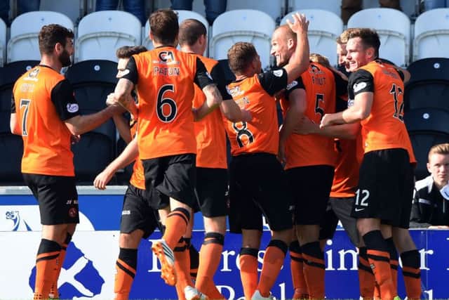 Dundee United's Jaroslaw Fojut (2nd from left) celebrates with team-mates. Picture: SNS