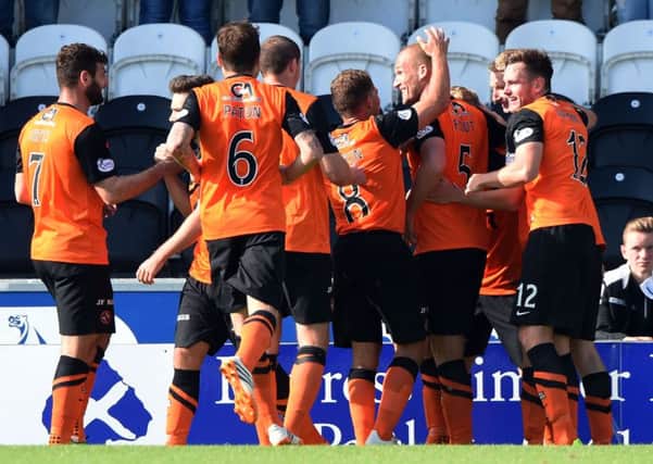 Dundee United's Jaroslaw Fojut (2nd from left) celebrates with team-mates. Picture: SNS