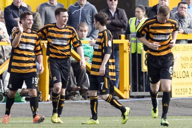 Alloa's Liam Buchanan, left, celebrates scoring against Hibs. Picture: SNS