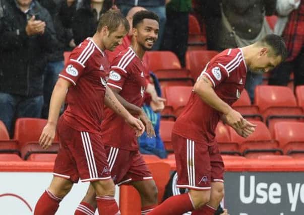Niall McGinn (left) celebrates his goal with Aberdeen team-mates Shaleum Logan (centre) and Ryan Jack (right). Picture: SNS