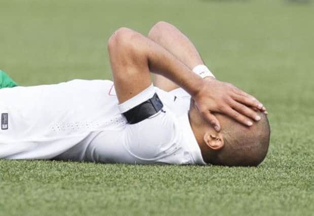 Hibernian striker Farid El Alagui hides his anguish as he lies injured on the Alloa pitch on Saturday. Picture: SNS