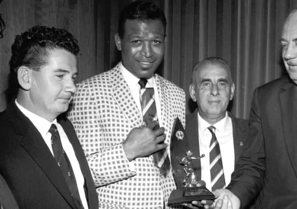 Sugar Ray Robinson is welcomed by Edinburgh City officials at the opening of their new social club in 1964. Picture: TSPL