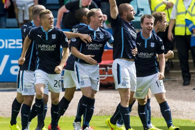 James McPake (3rd right) celebrates after giving Dundee the lead. Picture: SNS