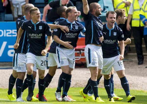 James McPake (3rd right) celebrates after giving Dundee the lead. Picture: SNS