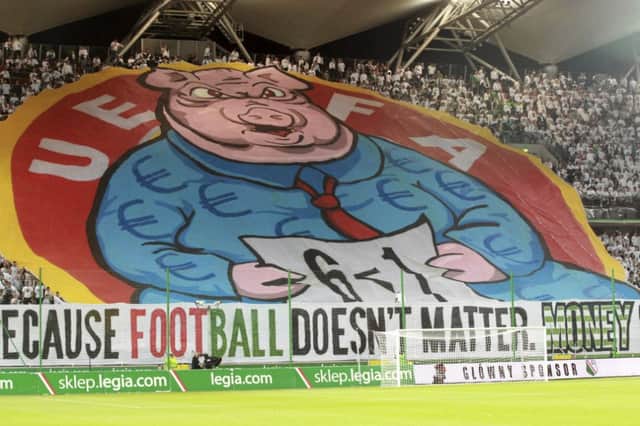 Legia Warsaw fans display the giant banner, taking a swipe at UEFA. Picture: Reuters