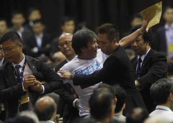 Leung Kwok-hung is dragged away by security guards. Picture: Reuters