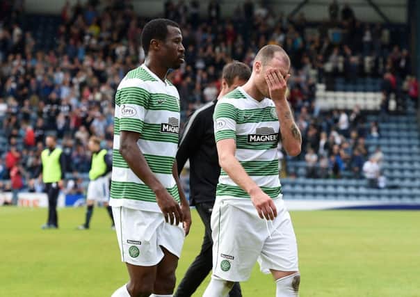 Efe Ambrose (L) and Anthony Stokes leave the pitch after Celtic's draw with Dundee. Picture: SNS