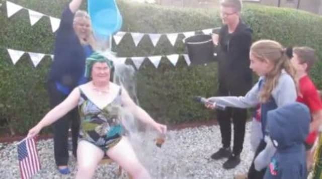 Cat Harvey drenches Susan Boyle in water. Picture: YouTube/Screengrab/Heart