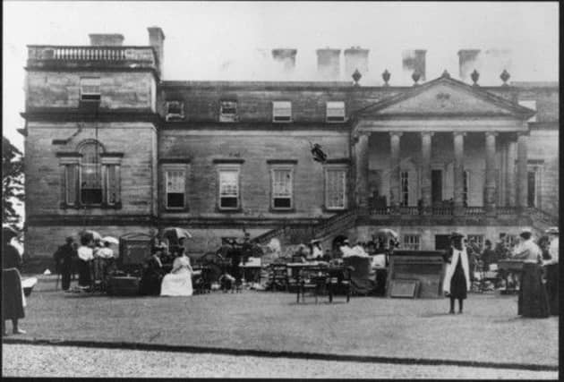Staff and family members watch as Penicuik House burns in 1899. Picture: Contributed