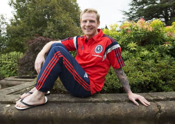 Scotland ace Chris Burke poses before employing his newly aquired camera and presentation skills. Picture: SNS