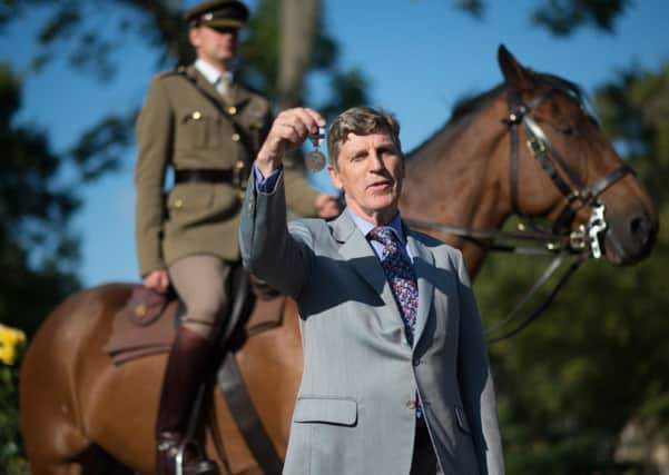 Author and broadcaster Brough Scott MBE, grandson of Warrior's owner and rider General Jack Seely, shows off the Honorary PDSA Dickin Medal. Picture: PA
