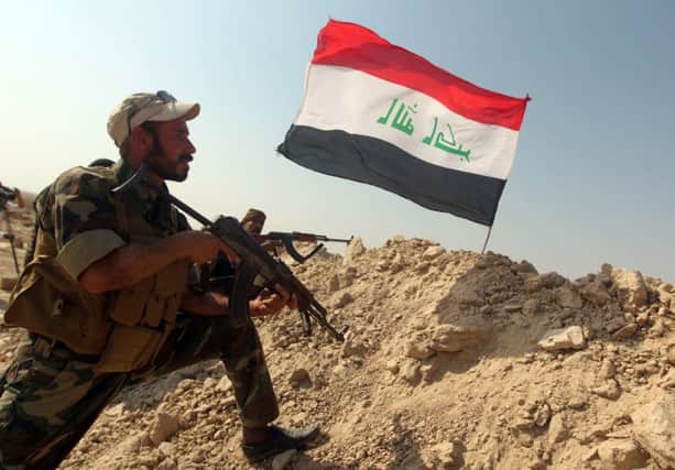 An Iraqi fighter guards a frontline position near Amerli. Picture: Getty